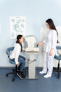 Optometrist assisting young girl with eye exam in a clinic setting.